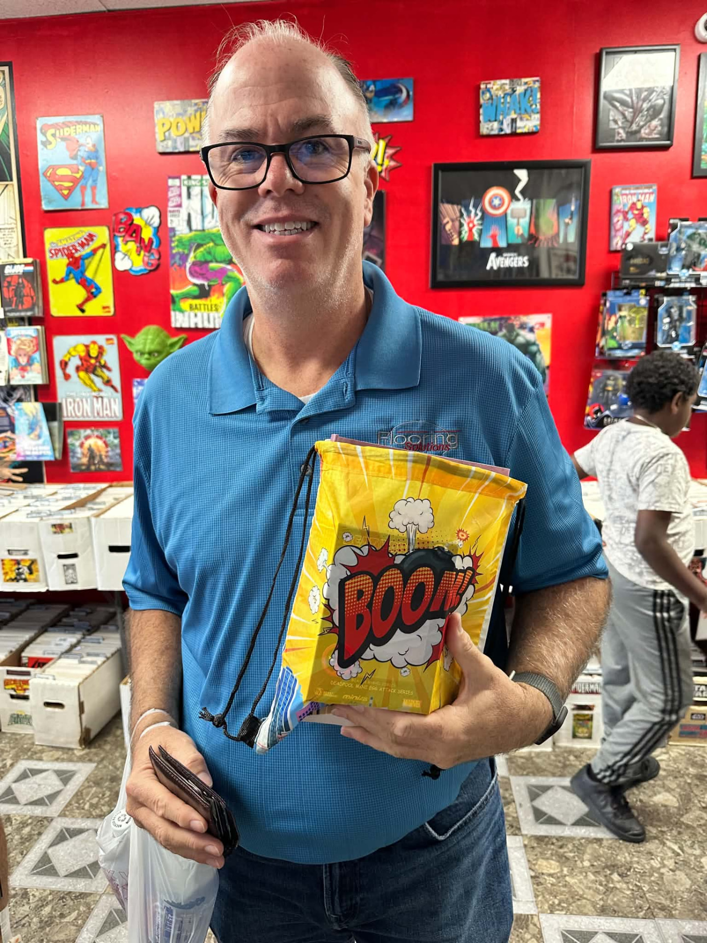A smiling customer holding a yellow Boom drawstring swag bag