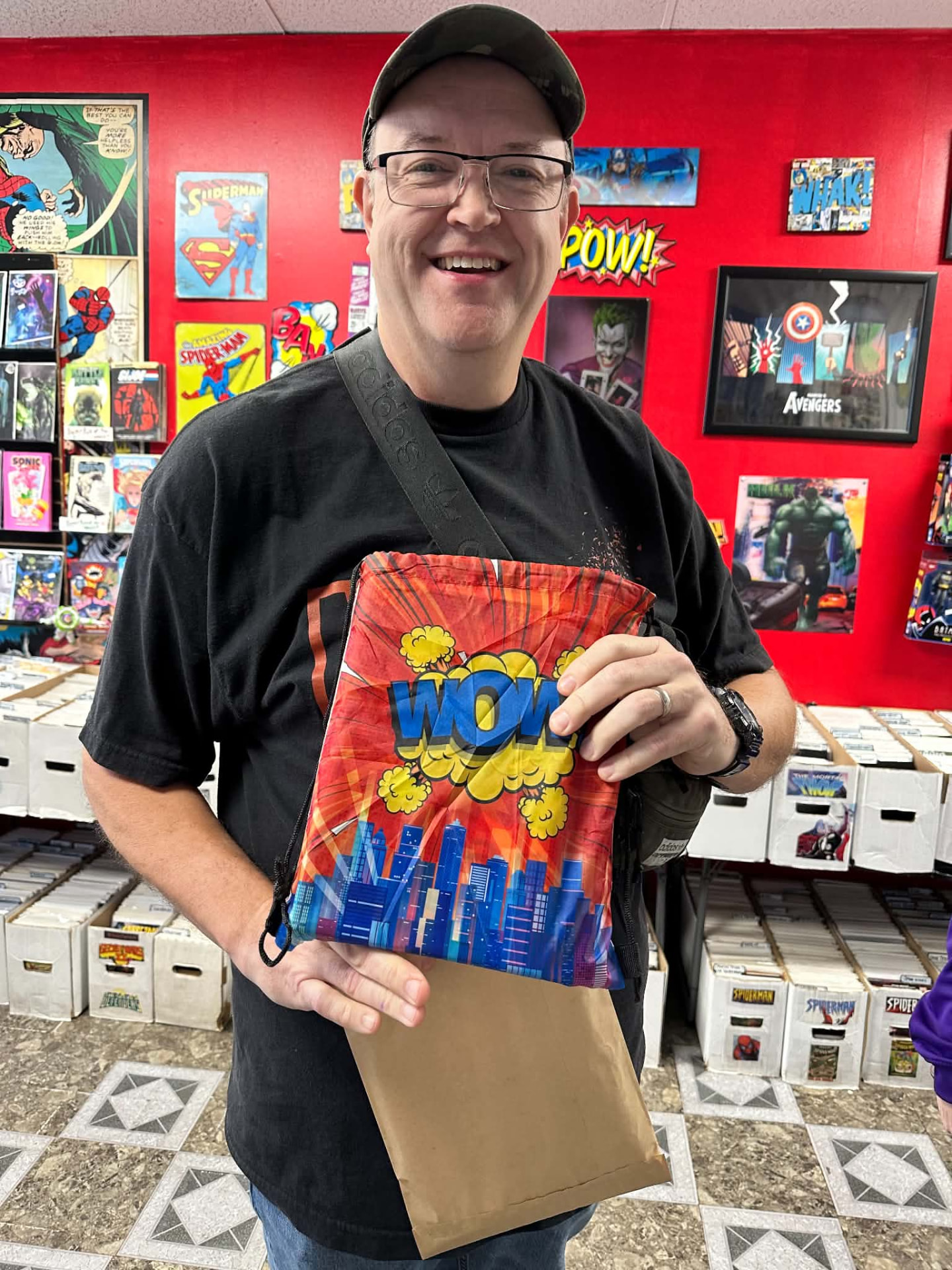 A customer holding a red Wow drawstring swag bag