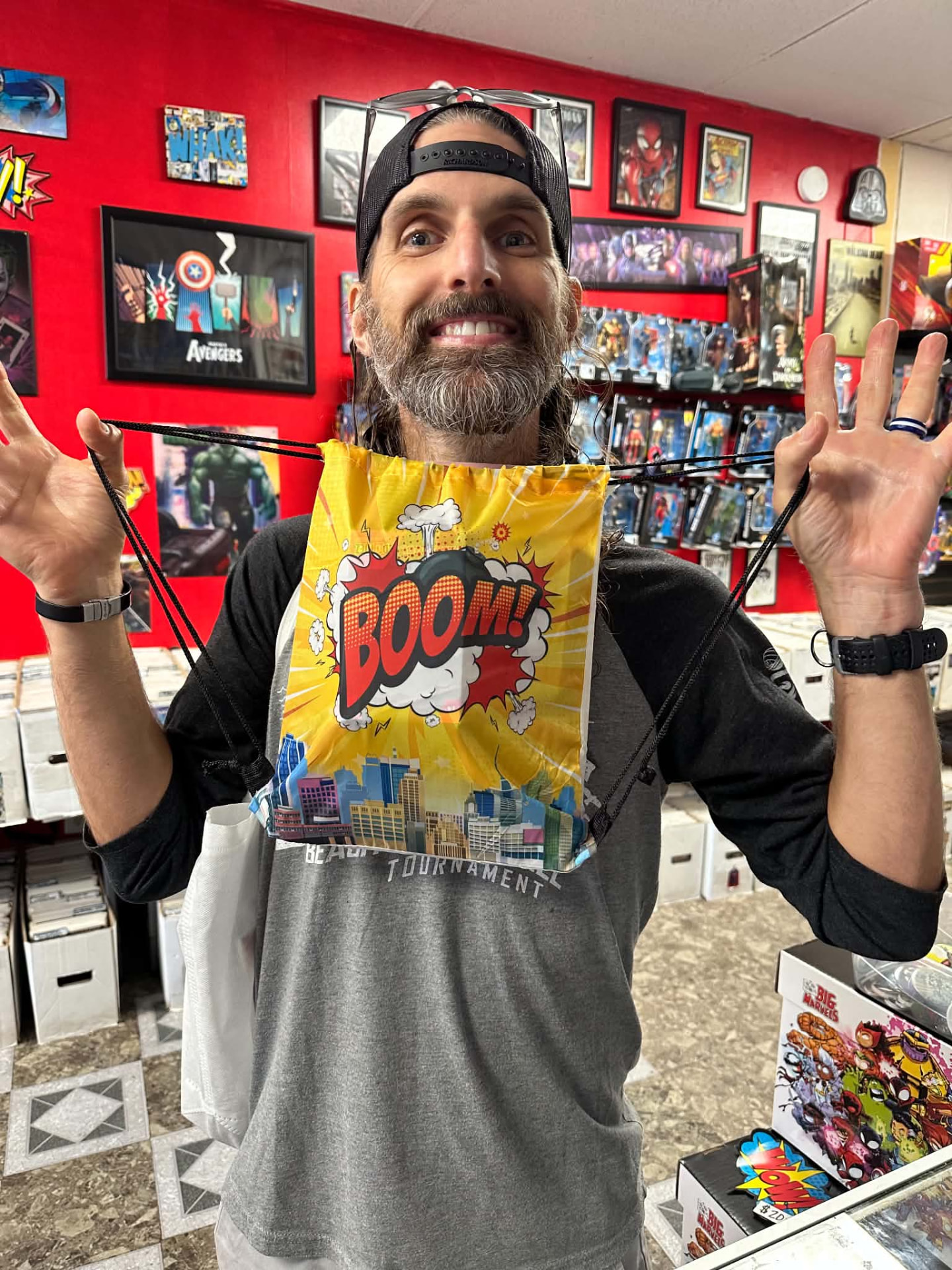 A beaming customer wearing a Boom swag bag stretched across his chest