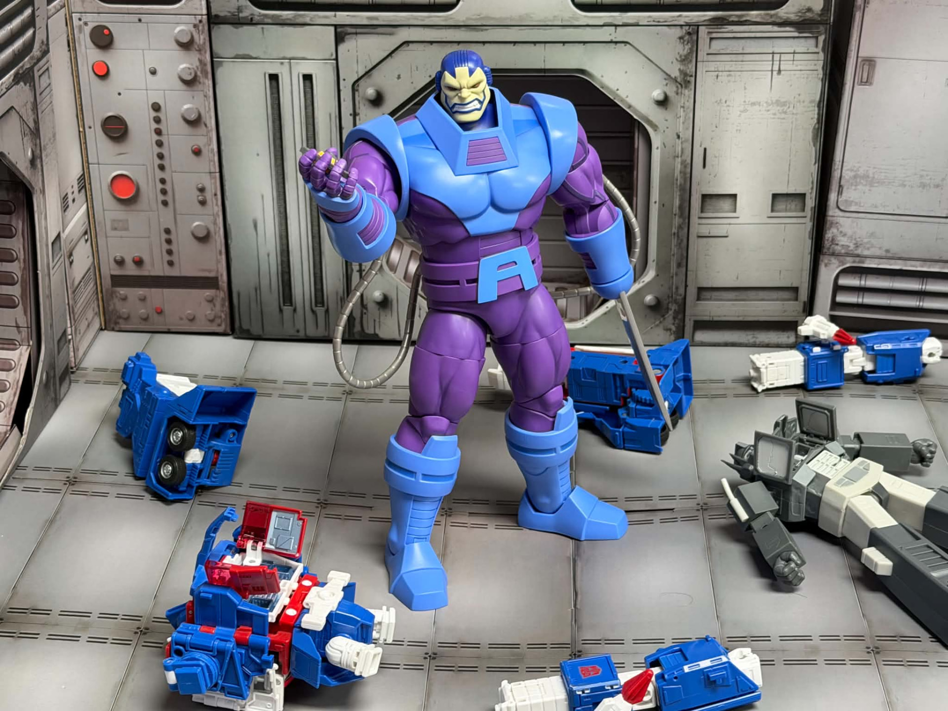 A giant purple armored villain towering over scattered robot figures