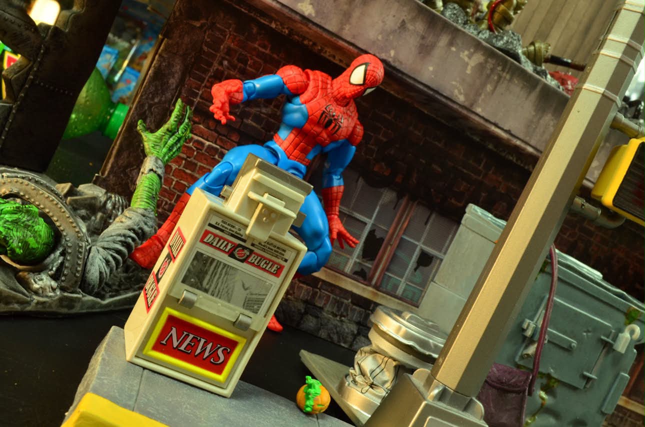 A web-slinger figure climbing a newspaper box over a sewer scene