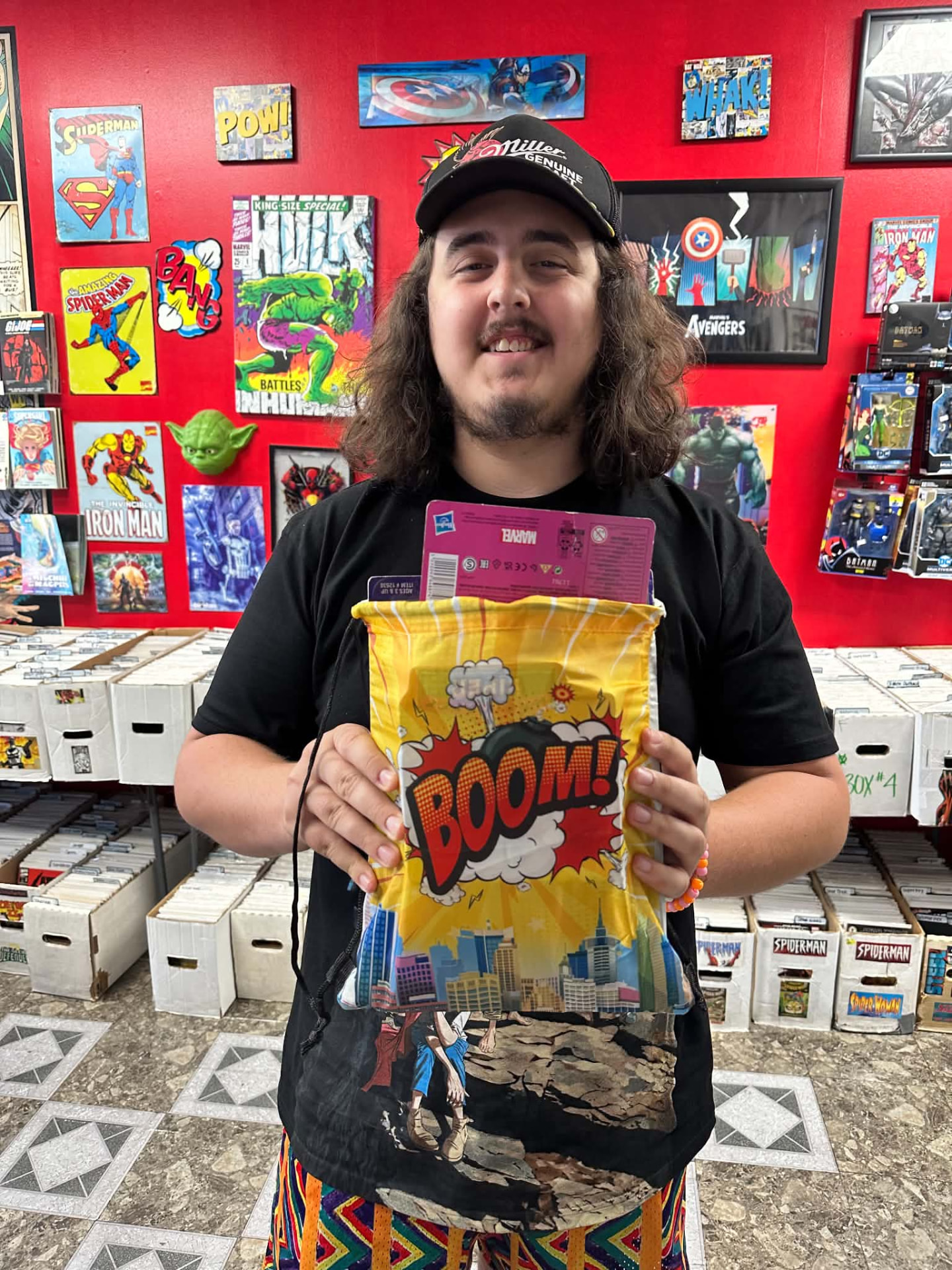 A young fan with a Boom swag bag and a boxed figure peeking out the top