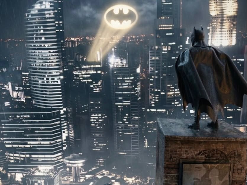 Moody finished figure photo on a rainy rooftop with a bat signal